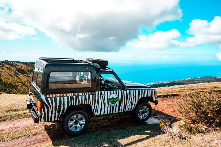 4x4 jeep touring Madeira mountain road — scenic viewpoint stop